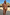 Thumbnail for Abstract Ruched Bikini Top in sunset tones with bead-trim straps, worn by a model in a beach setting.