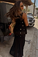 Black Alicia midaxi dress with a sequin-embellished crochet bodice and gathered chiffon skirt in a vacation look.