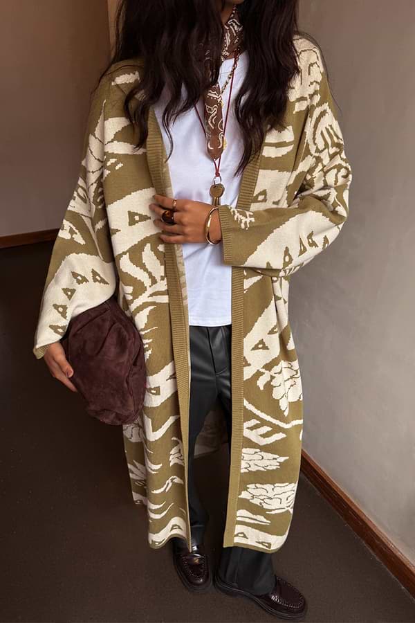 Olive Amara Knit Coatigan featuring cream heart and eye motifs in an oversized longline silhouette.
