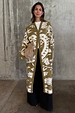 Olive Amara Knit Coatigan featuring cream eye and heart motifs, styled with black wide-leg trousers.