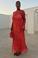 Coral Fawn Poppy Aria Dress in sheer mesh with a pink deer and orange poppy print, featuring flared sleeves.