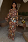 Brown Star Fawn Aria Mesh Dress with celestial motifs and flared sleeves on a model.
