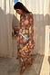 Star Fawn Aria Mesh Dress in brown with celestial motifs and flared sleeves in sheer mesh fabric, shown on a model.