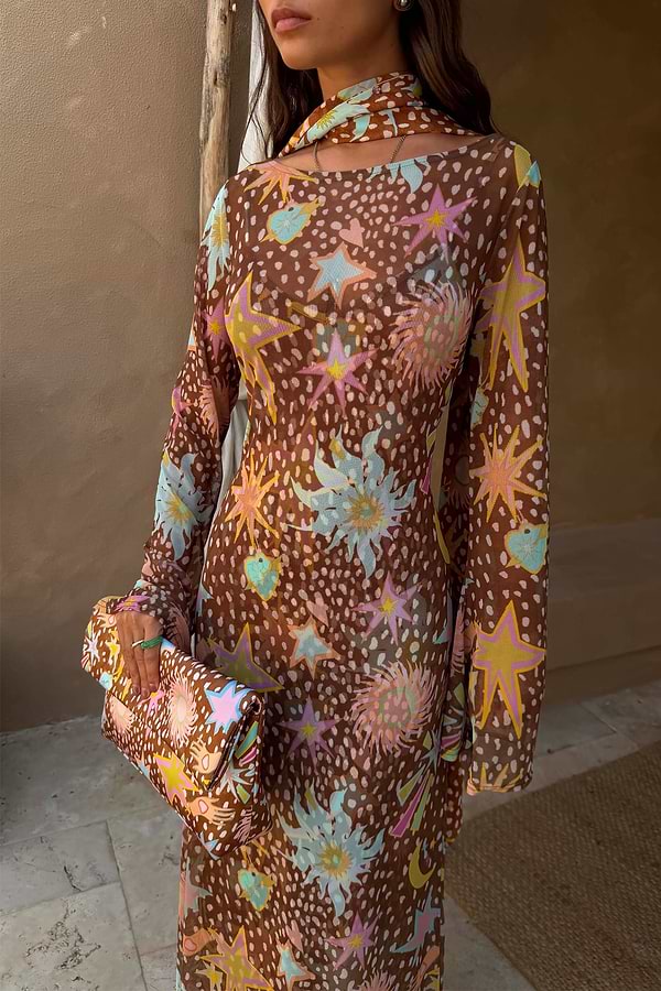 Star Fawn Aria Mesh Dress in brown with celestial motifs, flared sleeves and a matching printed clutch bag.