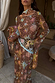 Star Fawn Aria Mesh Dress in brown with colourful celestial motifs, sheer fabric and flared sleeves.
