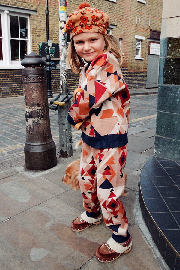 NFD Kids Aspen Jogger and matching jumper with a geometric print worn by a young girl on a London street.