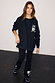 Black Sweatshirt with ecru signature embroidery in a slightly oversized fit, styled with matching embroidered trousers.