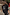 Thumbnail for Oversized black sweatshirt with ecru sun and snake embroidery, styled in a London setting with a red phone box.