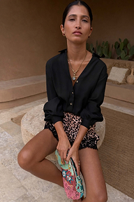 Black Miley Shirt with blouson sleeves and tortoise buttons, styled with leopard print lace shorts.