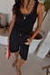 Black Studded Rib Vest featuring gold neckline detailing, styled with studded denim shorts and gold jewellery.