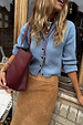 Ice Blue Studded Cardigan with silver metal studs and structured fit, styled with a suede skirt and burgundy bag.