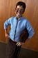 Thumbnail for Ice Blue Studded Cardigan with silver metal sleeve studs, styled with a dark brown skirt and clutch bag.