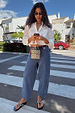 Blue Studded Barrel Jeans with side studs and a structured barrel leg, styled with a white shirt.