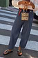 Blue Studded Barrel Jeans with silver side studs and a structured barrel leg, styled in a street style London look.
