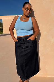 Ice Blue Studded Rib Vest with gold stud neckline detailing, styled with a dark denim skirt for a casual summer look.