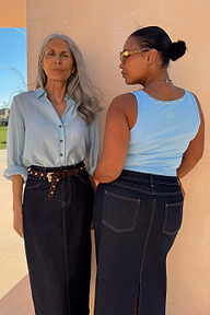 Ice Blue Studded Rib Vest with gold neckline studs, shown on two diverse models in dark denim skirts.