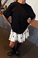 Black Bow Back T-Shirt in a relaxed fit with dropped shoulders, paired with a white bow-detail mini skirt.