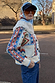 Bridget Cheryl Cardigan with blue and orange geometric motifs and a white wool collar in a street style setting.