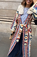 Cream Bridget Maxi Coatigan with blue and orange geometric motifs and a detachable wool collar in a street style setting.