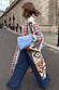 Bridget Maxi Coatigan in a blue and orange geometric knit, styled with wide-leg jeans on a London street.