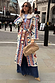 Bridget Maxi Coatigan with blue and orange geometric motifs and a detachable wool collar on a London street.
