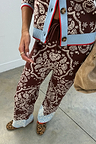 Chocolate brown bandana wide leg knit trousers featuring a blue contrast hem and drawstring waistband.