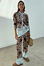 Chocolate Bandana Wide Leg Trousers with an iconic print and blue hem, styled with a matching cardigan co-ord.