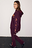 Burgundy hoodie with coral embroidery on the sleeve and matching wide-leg leggings on a model.