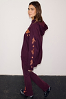 Burgundy hoodie with coral embroidery on the sleeve and matching wide-leg leggings on a model.