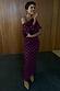 NFD Burgundy Tilly Dress in gold-flecked plisse, featuring a multi-wear off-the-shoulder neckline and lettuce hem.