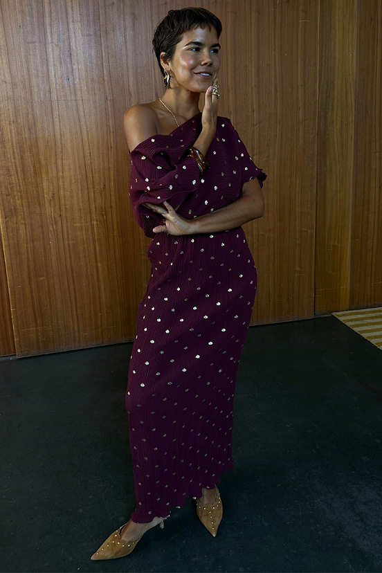Multi-wear Burgundy Tilly Dress in gold-flecked plisse fabric, styled off-the-shoulder on a model.
