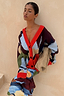 Thumbnail for Navy Abstract Callie Cardigan in an iconic artist print with red ribbed trims and button-up front on a model.