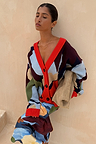 Navy Abstract Callie Cardigan in an iconic artist print with red ribbed trims and button-up front on a model.