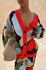 Navy Abstract Callie Cardigan in an iconic artist print with red ribbed trims and black buttons, styled off the shoulder.