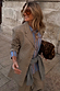 Grey Check Tailored Blazer layered with a striped shirt and leopard print clutch for a London street style look.