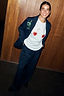 White cotton Cherry Boob T-Shirt with cherry chest prints, styled with a navy pinstripe suit.