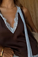 Chocolate Blue Lace Top featuring a deep brown base, light blue lace trim at the V-neckline and multi-wear ties.