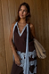 Chocolate brown multi-wear top with blue lace ties and trim, worn as a co-ord with the lace skirt.
