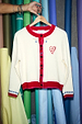 White Choose Love Cardigan in a knit with red trims, heart embroidery and blue cuff details.