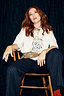 Thumbnail for White Choose Love T-shirt featuring a colourful graphic print, styled with navy pinstripe trousers on Angela Scanlon.