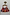 Thumbnail for Cirque Bag with red chequered print and hand-embroidered beaded motifs, hanging by its carved wooden leopard handle.