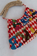 Cirque Bag with red checkered print, hand-embroidered glass bead animal and alphabet motifs and a carved wooden handle.