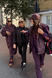 Dark Leopard Rain Mac in a waterproof recycled fabric, styled on a woman walking with her community in London.