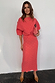 Thumbnail for Coral Plisse Tilly Dress with gold flecks, wide draped sleeves and a lettuce hem, styled with a pink clutch bag.