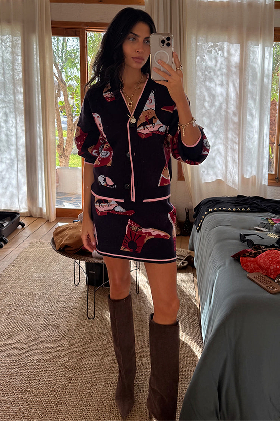 Navy Cowboy Boots Jake knit mini skirt featuring pink contrast trim and cowboy motifs, styled as a matching co-ord.