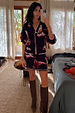 Navy Cowboy Boots Jake knit mini skirt featuring pink contrast trim and cowboy motifs, styled as a matching co-ord.