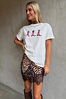 White boxy Cowboy Boot T-Shirt with colourful motifs, paired with a leopard print lace-trim mini skirt.