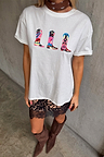 White cotton Cowboy Boot T-Shirt with multicoloured motifs, styled with a leopard lace skirt and brown boots.