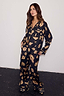 Thumbnail for Black Deloris Button Through Pyjamas with iconic gold motifs, worn by a 5ft7” model in a UK size 10.