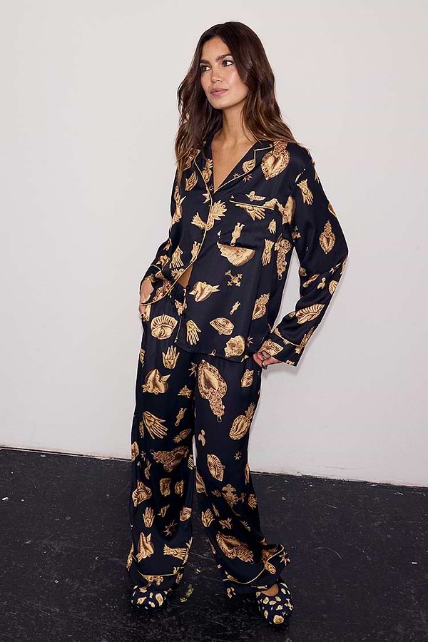 Black Deloris Button Through Pyjamas with iconic gold motifs, worn by a 5ft7” model in a UK size 10.